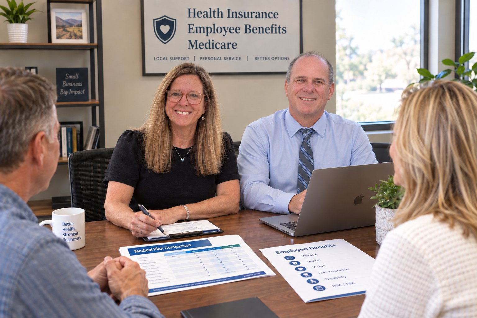 Bill Georgenton and a colleague reviewing employee benefits and plan options with clients